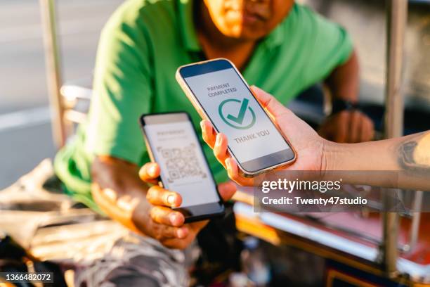 Staff scanning QR code to pay for taxi ride